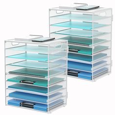 two clear drawers with files and folders on top of each drawer in front of one another