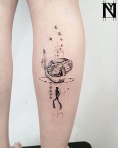 a woman's leg with a tattoo on it that has an image of a person in