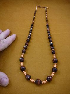 (Internal #V-500-10)  You are bidding on a beautiful, handmade 22" long, Copper bead necklace with Round textured copper beads 6 mm, flat rondell textured copper beads 4 mm, round copper spacer beads 4 mm, and diamond shaped copper beads 3 mm, with beautiful red tigereye beads: round 10 and 8 mm, and rice shaped 12x5 mm.SPECIALTY COPPER BEAD NECKLACE - GENUINE COPPER METAL with Copper circle and stick closure.This is the exact item you will receive.WE SHIP WORLDWIDE! Other accepted payment: Cred Brown Single Strand Round Bead Jewelry, Brown Wooden Beads Oval Jewelry, Brown Jewelry With Oval Wooden Beads, Brown Wooden Oval Beads Jewelry, Copper Spacer Beads Jewelry, Hand-strung Brown Necklaces For Jewelry Making, Brown Copper Jewelry With Spacer Beads, Traditional Brown Oval Beads Jewelry, Brown Jewelry With Polished Round Beads