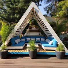 an outdoor living area with blue couches and plants