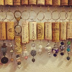 several wine corks are hanging on the wall and there is a key chain attached to it