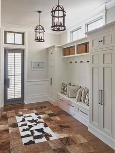 an image of a room with some white cabinets and drawers on the wall next to a large rug