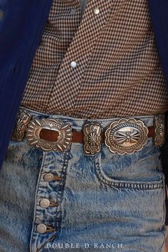 A CLASSIC CONCHO BELT IS A SOUTHWESTERN STAPLE. How stunning is this contemporary concho belt? The slender leather strap is adorned with 7 classic sterling silver scallop conchos alternated by 8 butterfly concho spacers, and finished with a complementing concho frame buckle. Timeless and classic – a must-have for every cowgirl’s closet. materials: sterling silver, leather strap dimensions on buckle 2 1/2" 7 conchos at 2 1/2" x 2 1/4" 8 butterfly spacers 2" x 1" belt fits 32" weight: 416 grams ni Classic Antique Belt Buckles For Ranch, Classic Concho Belt Buckles, Formal Adjustable Concho Belt, Classic Concho Belt Buckles For Rodeo, Vintage Silver Embroidered Belt, Western Silver Embroidered Belt, Classic Adjustable Embroidered Belt, Classic Concho Belt For Western-themed Events, Vintage Concho Belts For Rodeo