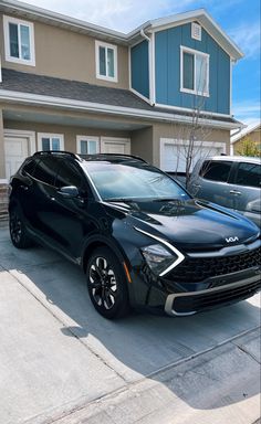 a black car parked in front of a house