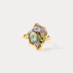 Elevate your jewelry collection with the enchanting allure of our Purple Pearl Tulip Flower Ring. This exquisite piece captures the delicate beauty of nature with its intricately crafted tulip flower design, accentuated by lustrous pearls set against a backdrop of rich, deep purple enamel. Crafted from 18K gold-plated brass, this ring exudes luxury and sophistication, making it a timeless accessory that adds a touch of elegance to any ensemble. Its unique design and vibrant color palette make it Delicate Gold Flower Ring With Gemstone, Gold Flower Ring Nature-inspired, Exquisite Yellow Gold Flower Ring As Gift, Exquisite Yellow Gold Flower Ring For Gift, Gold Flower-shaped Nature-inspired Rings, Gold Nature-inspired Flower Ring, Nature-inspired Gold Flower Ring, Elegant Birth Flower Ring, Elegant Open Ring With Birth Flower