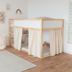 a child's bedroom with a bunk bed and curtains