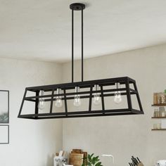 a kitchen light hanging over a counter top next to a pot rack with utensils on it