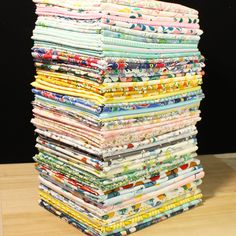 a stack of cloths sitting on top of a wooden table