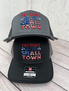 two hats with the words try that town written in red, white and blue on them