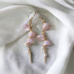 🌸 Introducing our Japanese vintage style earrings that are in the shape of lily of the valley. 🌸 The dangles showcase intricately designed Chinese elements, adding a cute and elegant touch to your look. 🌸 What's unique about Lily of The Valley: A symbol of purity, joy, love, sincerity, happiness and luck, lily of the valley has much significance beyond the United Kingdom. It's actually the national flower of Finland, and in France, on 1st May for La Fête du Muguet, lily of the valleys are gifted to loved ones. 🌸 Crafted with hypoallergenic materials, these earrings offer a comfortable and safe wearing experience.  🌸 The lightweight design makes them perfect for everyday wear or as an exquisite accessory for formal events. 🌸 Ideal for various occasions, including weddings, parties, or Dangle Flower Earrings With Ear Wire For Anniversary, Anniversary Dangle Flower Earrings, Mother's Day Anniversary Dangle Flower Earrings, Mother's Day Anniversary Flower Dangle Earrings, Feminine Dangle Bridal Earrings, Mother's Day Pearl Drop Earrings, Feminine Dangle Earrings For Anniversary, Kawaii Earrings, Vintage Style Earrings