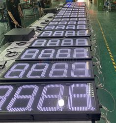 there are many electronic signs on the conveyor belt at the factory, all displaying letters and numbers