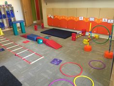 an indoor play area with various colored circles and blocks on the floor in front of lockers