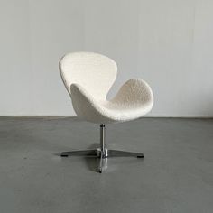 a white chair sitting on top of a cement floor