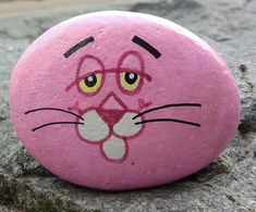 a pink rock with a face painted on it