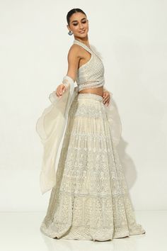 Ivory lehenga featuring floral motifs embellished by pearls, sequin and zircons on a shimmer base. Comes with padded bead embellished tasselled blouse and ruffle dupatta. - Aza Fashions Off White Sharara With Sheer Dupatta For Reception, Party White Lehenga With Chikankari Embroidery, Cream Sets For Wedding And Navratri, Cream Set For Wedding And Navratri, Elegant Cream Lehenga For Navratri, Wedding Lehenga In Off White With Cutdana, Designer Off-white Lehenga With Pallu, Off White Lehenga For Reception And Navratri, Off-white Sharara With Sheer Dupatta For Reception