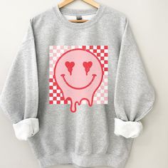 Retro Smiley Face sweatshirt, Distressed Vintage Look Smiley face, Crewneck sweatshirt, Retro smile, smile graphic sweater, valentines, melted smiley face, good vibes, positivity, Be Happy, Brahman Darlin Thank you for shopping my small business. Please message me if you have questions. This is a physical shirt that is made when you order it and shipped out to you. I do not sell my designs, they are made with love, by me to support my family's cattle ranch. If you love the design and would like Funny Relaxed Fit Sweatshirt For Streetwear, Trendy Long Sleeve Sweatshirt With Funny Print, Casual Winter Tops With Smiley Face, Casual Smiley Face Winter Tops, Casual Funny Print Winter Sweatshirt, Casual Winter Sweatshirt With Funny Print, Casual Sweatshirt With Heart Graphic For Loungewear, Fun Cotton Sweater With Graphic Print, Fall Smiley Face Sweatshirt For Streetwear