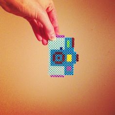 a hand is holding a piece of lego