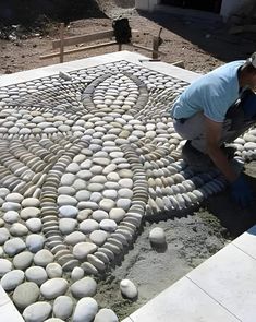 a man working on some kind of rock art