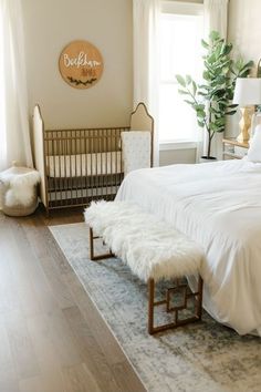 a white bed sitting in a bedroom next to a baby crib