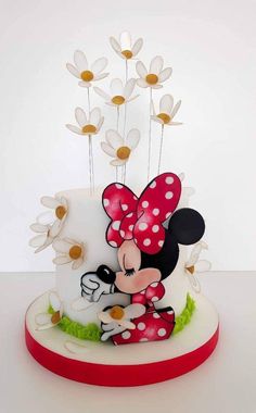 a minnie mouse cake with daisies on top