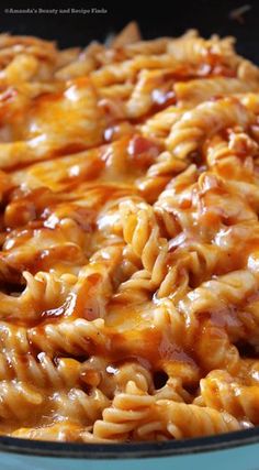 a casserole dish filled with macaroni and cheese in a blue bowl