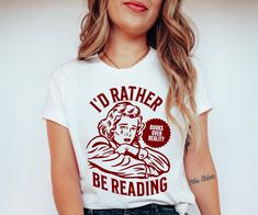 Hey book lover, show off your love for Reading with our retro I'd rather be reading Shirt. The perfect Bookish sweatshirt for Fantasy Readers, Bookworms, Romance Book Lovers, Librarians, Book Nerds and Book club members All designs are available on tshirts/sweatshirts/hoodies. Send me a message if you can't find the product you need! MATERIAL This t-shirt is everything you've dreamed of and more. It feels soft and lightweight, with the right amount of stretch. It's comfortable and flattering for Bookish Tshirt, Reading Tshirt, Reading Shirts, Book Addict, Book Lovers Gifts, Book Lover, Book Nerd, Book Club, Book Lovers