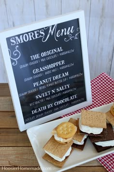 there is a sign that says smores menu next to some crackers on a plate