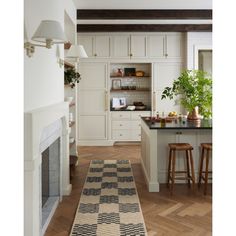 a kitchen with an area rug on the floor