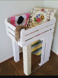 a white bench with two pillows on top of it and a pillow in the middle