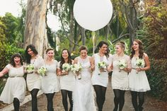 a group of women standing next to each other in front of a white ballon