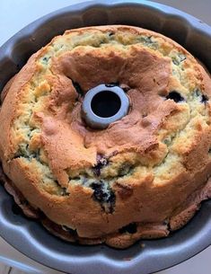 a blueberry bundt cake in a pan on a counter top with a metal ring