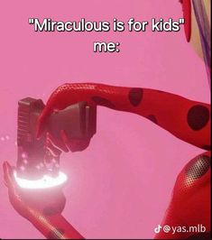 a person holding a camera in front of a pink background with the words,'miracubus is for kids me '