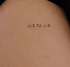 a woman's back with the words visa vie written on her left side ribcage