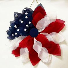 a red, white and blue wreath hanging on a wall