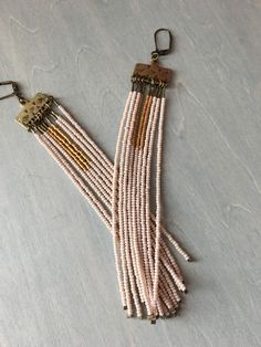 the beaded necklace is hanging on a hook