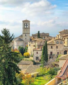 an old town with trees and buildings in the background