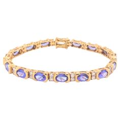 Vintage Tanzanite and Diamond Bracelet in 18k Yellow Gold. This gorgeous bracelet features 16 oval tanzanites, totaling ~11.36 carats, bezel set with 2 round brilliant diamonds between each tanzanite for a total of 32 diamonds weighing ~0.71 carats. The diamonds are G in color and VS-SI in clarity. The bracelet is secured with a slide in clasp and 2 security side clasps. The bracelet is approximately 7.30 inches long and 5.60 mm wide and the total weight is 24.6 grams. It would fit a wrist size Gold Vintage Bracelet, Vintage Gold Bracelet, Bracelet Tennis, Modern Bracelets, Vintage Sapphire, Tanzanite Diamond, Sapphire Bracelet, Vintage Bracelet, Yellow Gold Bracelet