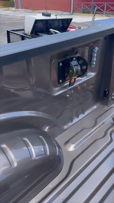 the inside of a pickup truck with its door open and an electrical outlet in the center