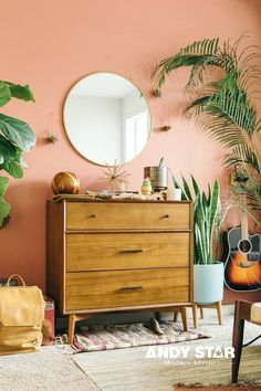 a living room filled with furniture and lots of greenery in front of a round mirror