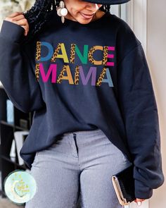 Dance Mama, Dance Shirts, Gifts for Mom, Leopard and Leotards, Toddler Dance, Dance Troop, Team Mom Tshirt, Leopard Print, Hip Hop Dance, Ballet Mom, Cheerleading Tees, Shirts for Mom, Mama Sweatshirt This soft sweatshirt has a loose fit for a comfortable feel. With durable print, it will be a walking billboard for years to come. -Loose fit -50% Cotton; 50% Polyester (fibre content may vary for different colors) -Unisex - Fits true to size (see size chart for reference) - If you prefer an oversi Black Tops With Letter Print For Dance Class, Black Letter Print Dance Top, Long Sleeve T-shirt With Letter Print For Dance, Long Sleeve Letter Print T-shirt For Dance, Long Sleeve Cotton T-shirt For Dance Class, Long Sleeve Graphic T-shirt For Dance, Hip Hop Long Sleeve Sweatshirt For Dance, Stretch Black Top For Dance Class, Long Sleeve Graphic Print T-shirt For Dance