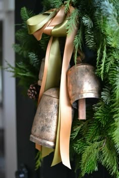 a christmas wreath with bells hanging from it