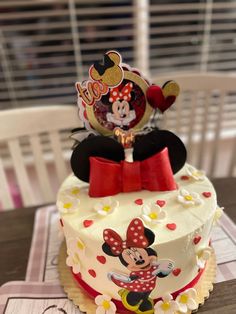 a birthday cake decorated with a minnie mouse topper