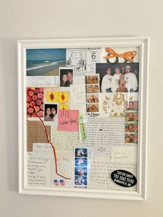 a collage of photos and letters is displayed on a white framed wall above a post - it note board