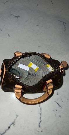 a handbag is sitting on a marble surface