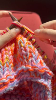 someone is crocheting something with scissors in their hands and they are all knitted together