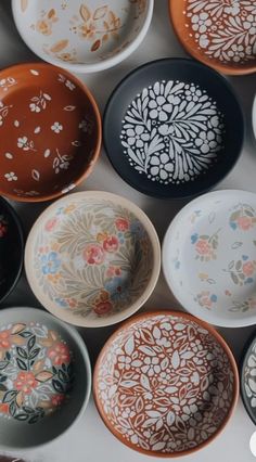 many different colored bowls with designs on them