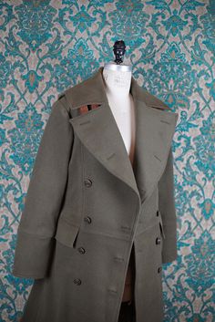 ABOUT THIS STYLE: Our overcoats are made from the heaviest and most durable wools sourced from the US, Canada, and England. This coat is cut from olive wool melton with a quilted burgundy undercollar trimmed in brown. A waxed pull-up cowhide is used to make the back belt of the coat and the undercollar straps. The two-toned pull-up leather gains more character as it is worn and folded. The style features 5 buttons on the cuffs, solid brass buckles, plastron front seaming. Our convertible collars Convertible Collar, Oct 30, Brass Buckle, Denver Co, Muslin Cotton, Pull Up, Wool Fabric, Fabric Swatches, Double Breasted Suit Jacket