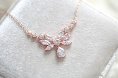 A dainty yet glamorous bridal necklace to add a touch of romance to your wedding! This rose gold necklace features an array of intricately cut cubic zirconia stones that shine brilliantly!Perfect for the bride or a bridal party !- Available in rose gold, yellow gold or rhodium finish- 17" (Length) - 1/16" (Width)- 3/4" (Drop) This is an original design by © Treasures by Agnes Dainty Rose, Bridal Necklace, Rose Gold Necklace, Gold Yellow, Diamond Wedding Bands, Bridal Party, The Bride, Cross Necklace, Original Designs