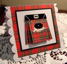 a card with a tartan plaid pattern on it and a black button in the middle