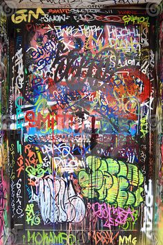 a wall covered in lots of colorful graffiti